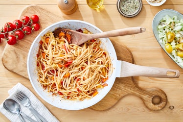 Healthy vegetarian pasta, made of cherry tomato, red pepper, carrots, onion and garlic, in a pan, wi...