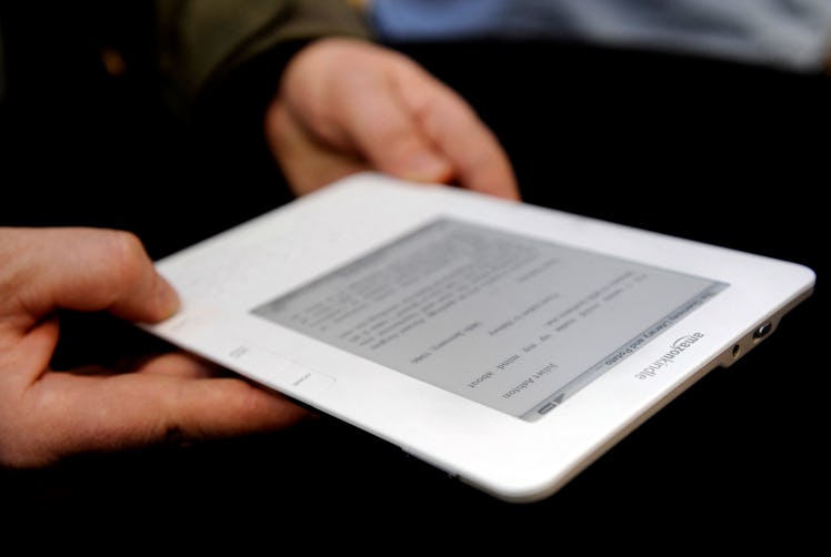 People test a Kindle 2 after a press conference unveiling latest version of Amazon's popular electro...