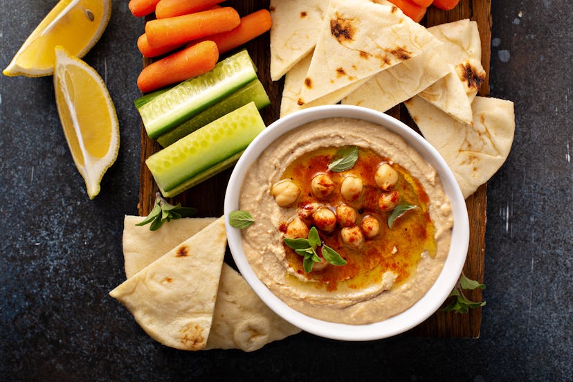 Homemade hummus served with flatbread and vegetables