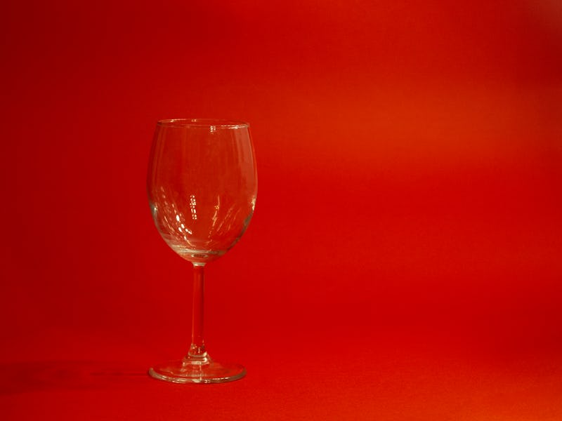 Empty glass on red background