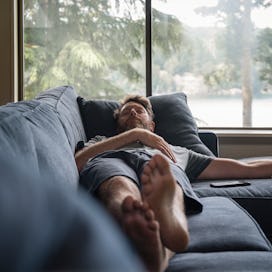 A man sleeping on a couch.