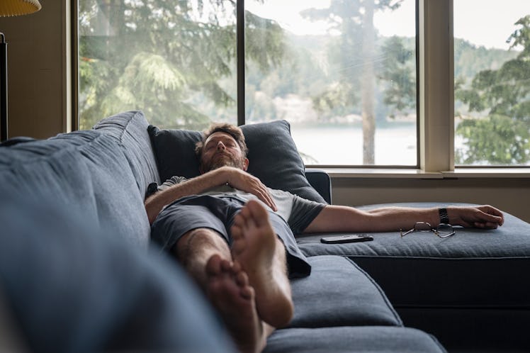 A man sleeping on a couch.