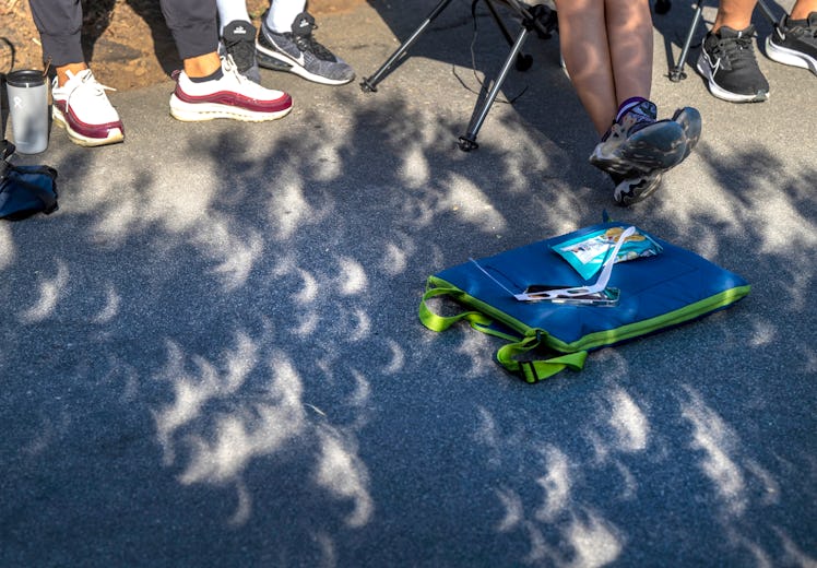 San Juan Capistrano, CA - October 14: Crescent shadows are cast on the pavement during the annular s...