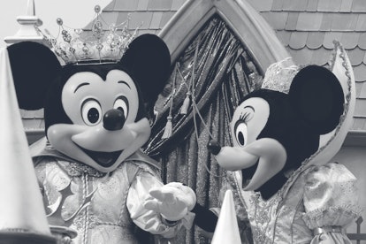 ANAHEIM, UNITED STATES:  Mickey and Minnie Mouse hold hands as they parade down Main Street, USA in ...