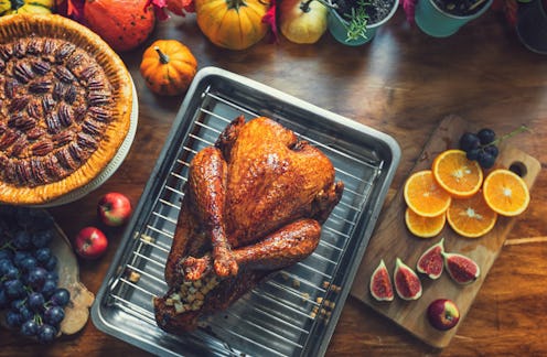 Preparing traditional stuffed turkey with side dishes for Thanksgiving celebration