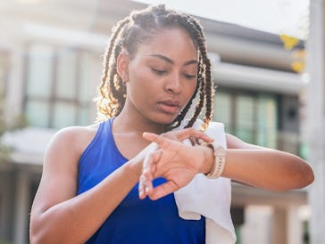 Woman using smart watch before running