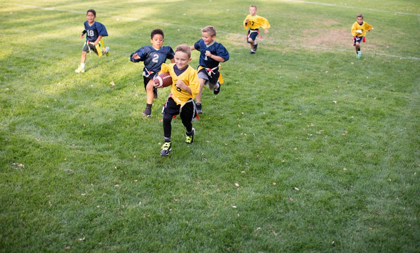A young flag football player runs with the football, in a story answering the question, how old does...