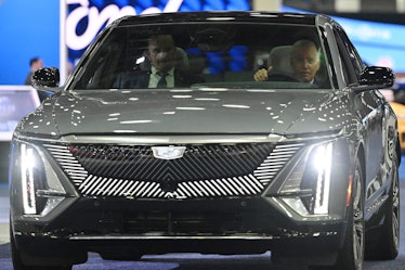 US President Joe Biden sits at the wheel of a Cadillac Lyriq electric vehicle as he visits the 2022 ...