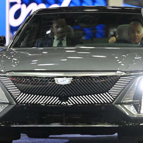 US President Joe Biden sits at the wheel of a Cadillac Lyriq electric vehicle as he visits the 2022 ...