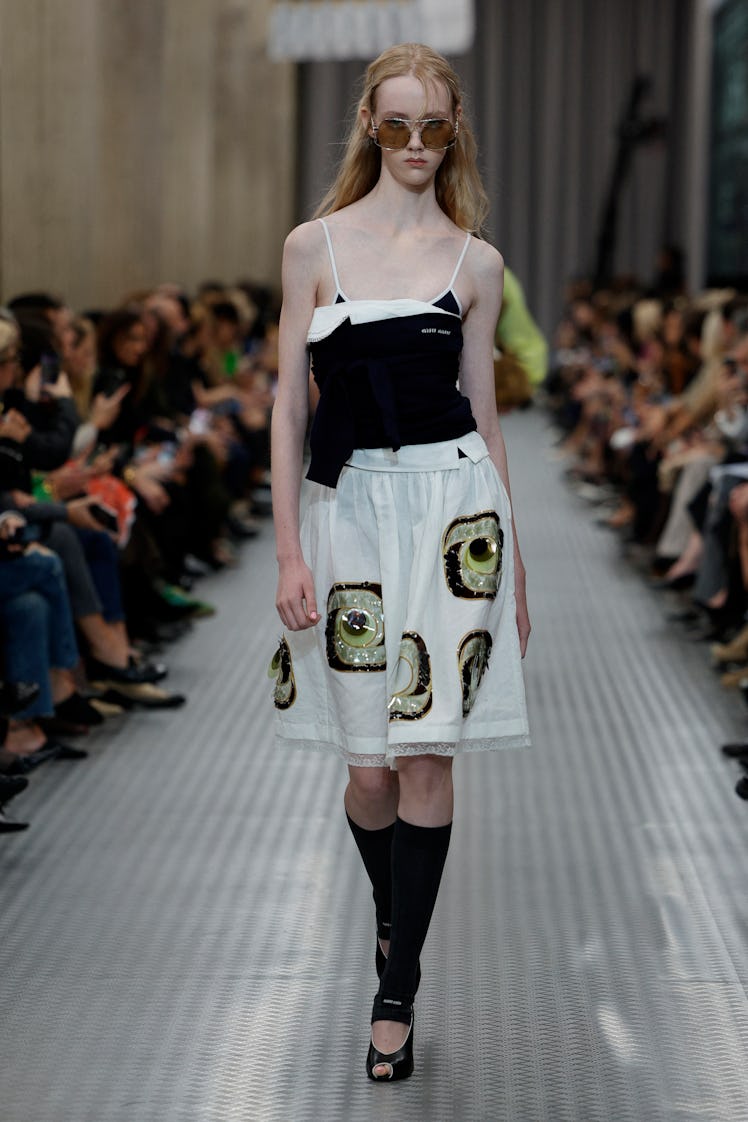 A model presents a creation by Miu Miu for the Women Ready-to-wear Spring-Summer 2025 collection as ...