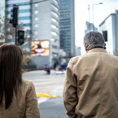 Coworkers walking and talking outdoors