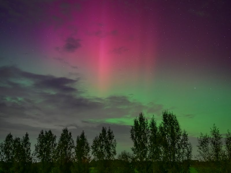 DALFSEN, NETHERLANDS - OCTOBER 10: Northern lights or aurora borealis In the night sky over the rive...