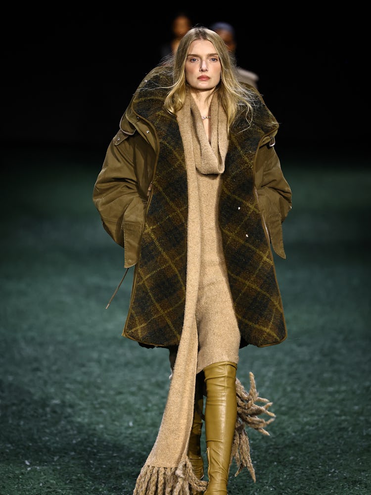 A model presents a creation during a catwalk presentation for British fashion house Burberry's Autum...