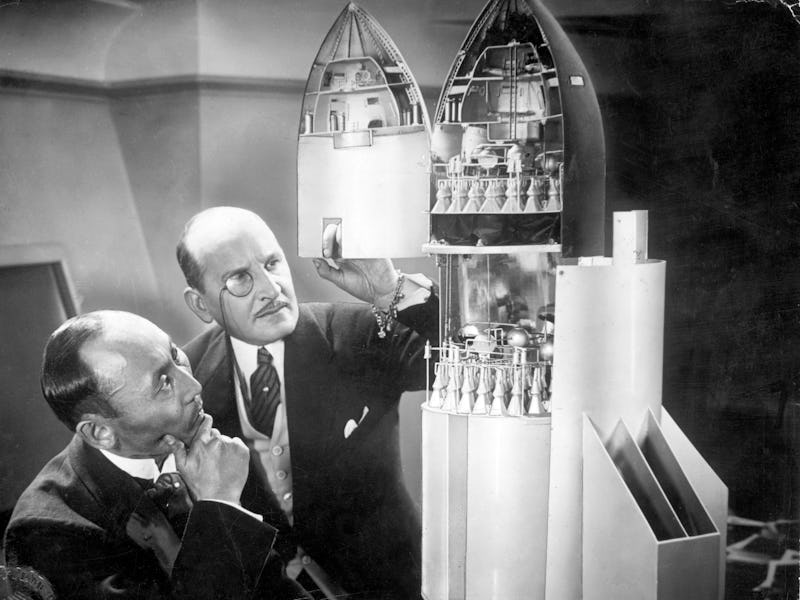 Still from 1929 German movie Frau im Mond (The Woman in the Moon). Investors examine a model of the ...