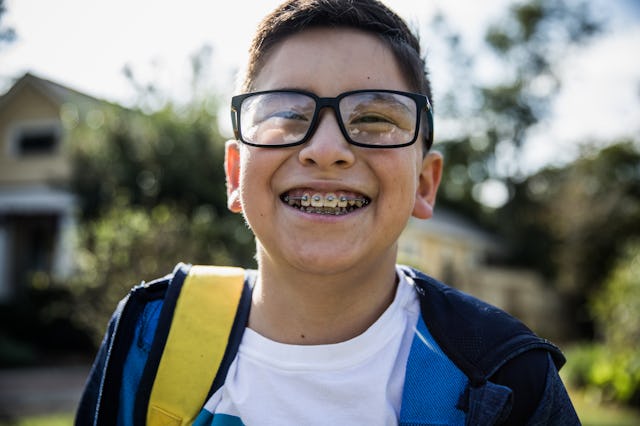 School age boy laughing outside