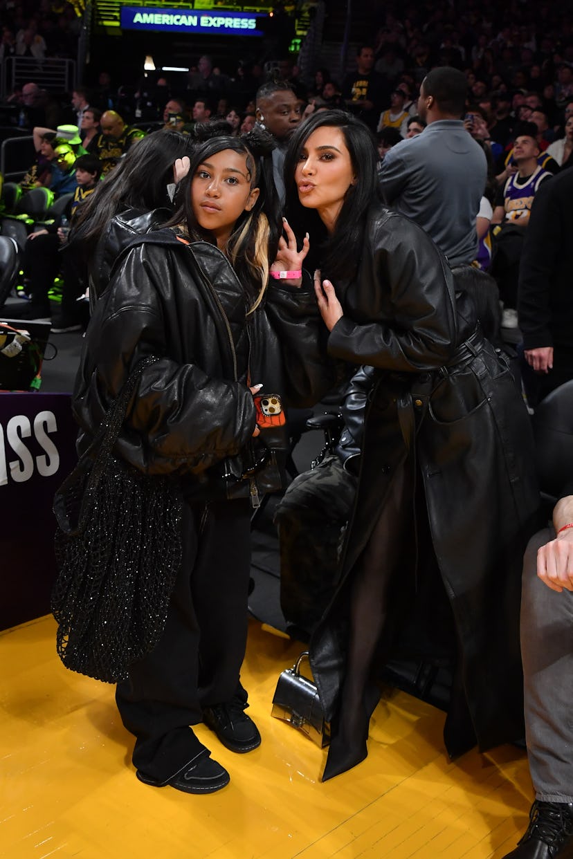 LOS ANGELES, CALIFORNIA - APRIL 09: Kim Kardashian (R) and North West attend a basketball game betwe…
