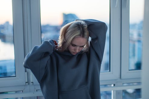 Young blonde woman on balcony.