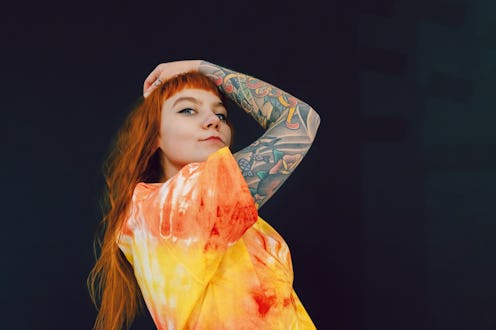 Portrait of confident red-haired young woman