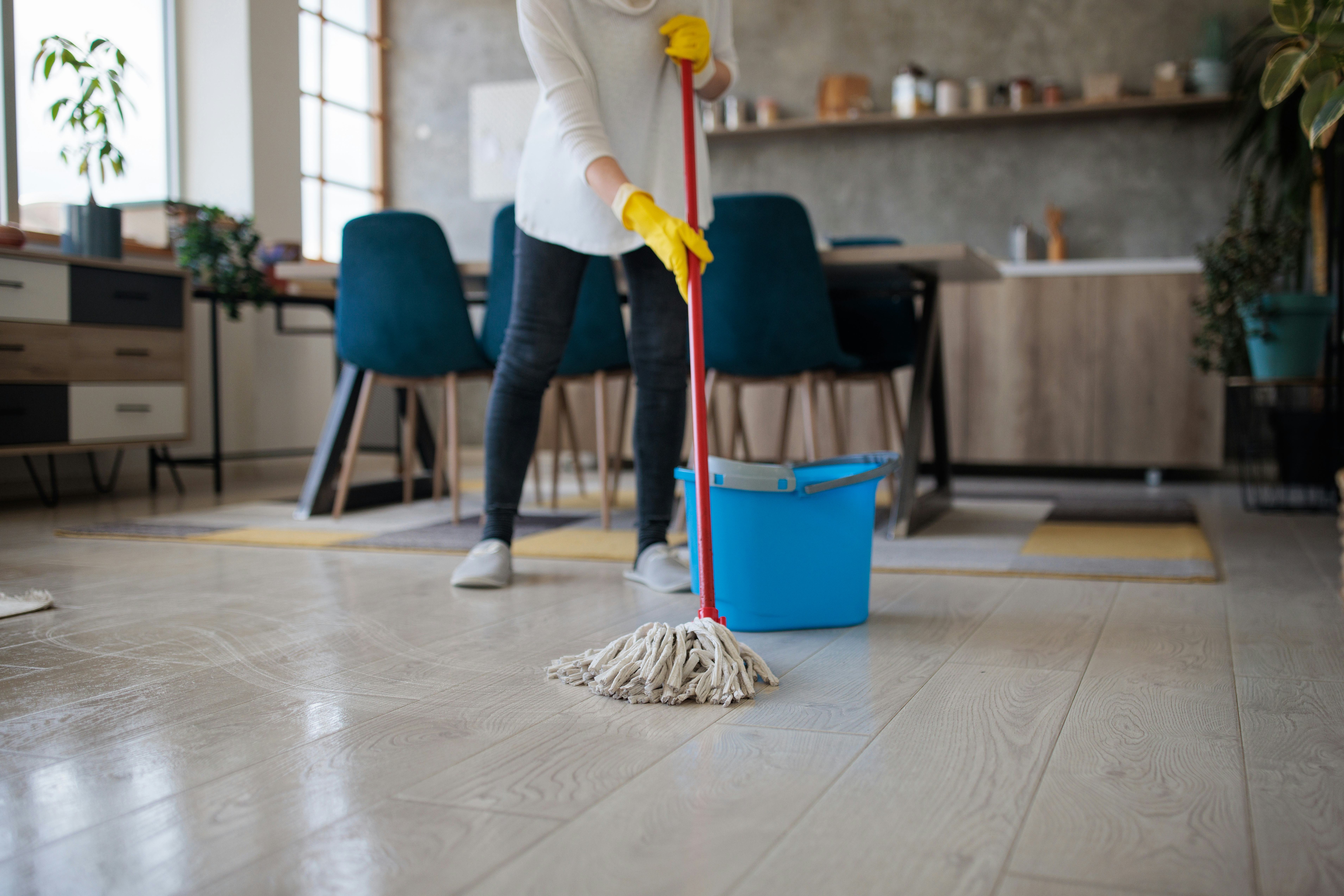 Unrecognizable woman in her forties cleaning indoors