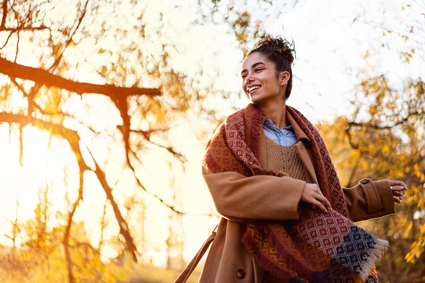 Beautiful young woman enjoying a carefree autumn day outdoors.