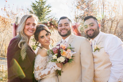 Bride and groom with best man and maid of honor posing at outdoor wedding