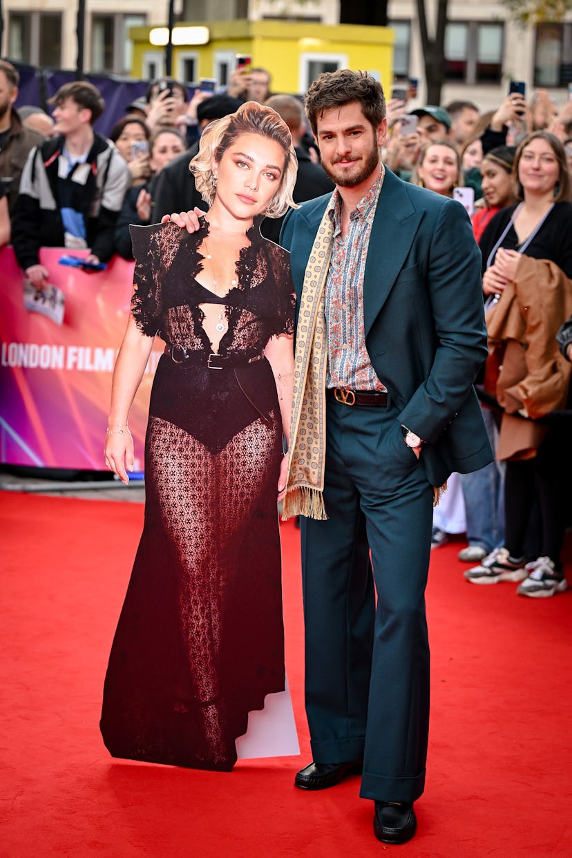 LONDON, ENGLAND - OCTOBER 17: Andrew Garfield poses with a cardboard cutout of Florence Pugh during ...