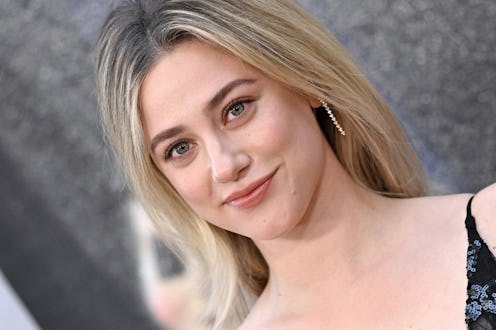 Lili Reinhart attended Giorgio Armani fashion show in a plunging low-cut dress.