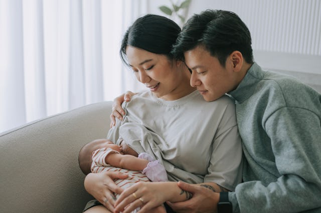 A couple gazes at their new baby.