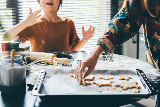 Family cooking Christmas cookies at the kitchen.