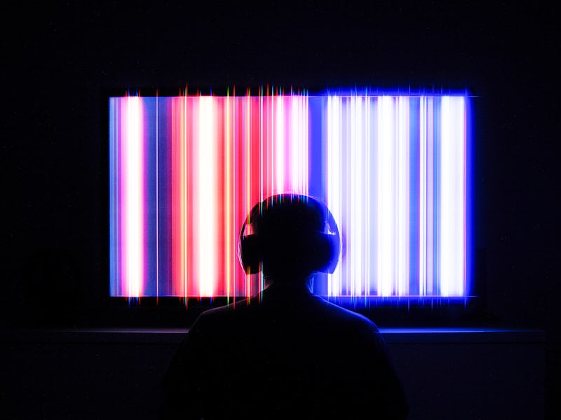 Person in front of TV screen with headphones