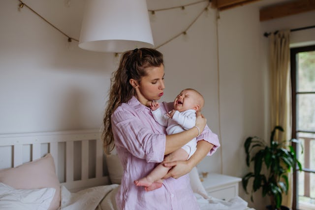 A mom holds a fussy baby. A new study has found that stresed-out moms are less responsive parents.