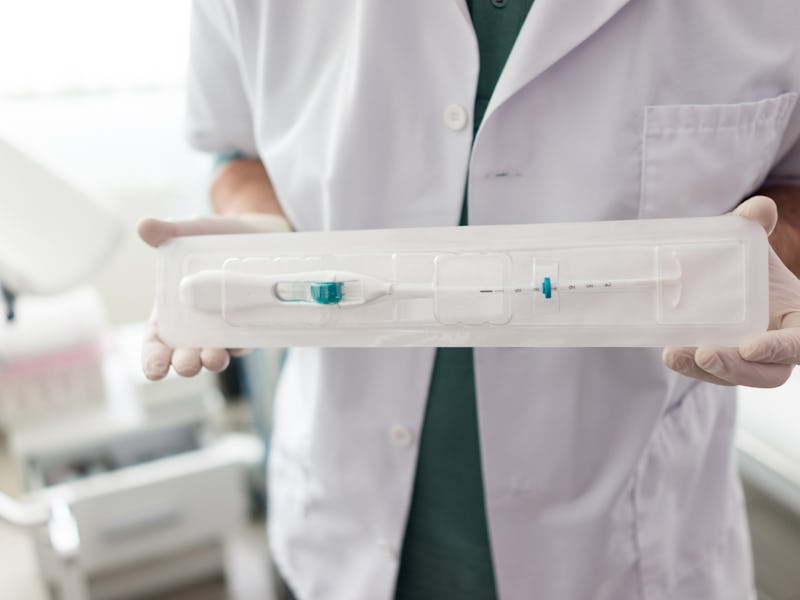 Doctor in hospital holding IUD
