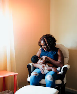 Black mom breastfeeds her baby