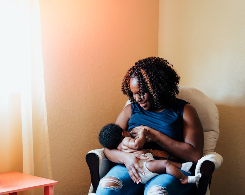 Black mom breastfeeds her baby