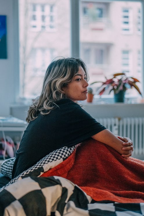 Woman waking up, looking out of window, spending day at home, working, getting ready, going outside ...