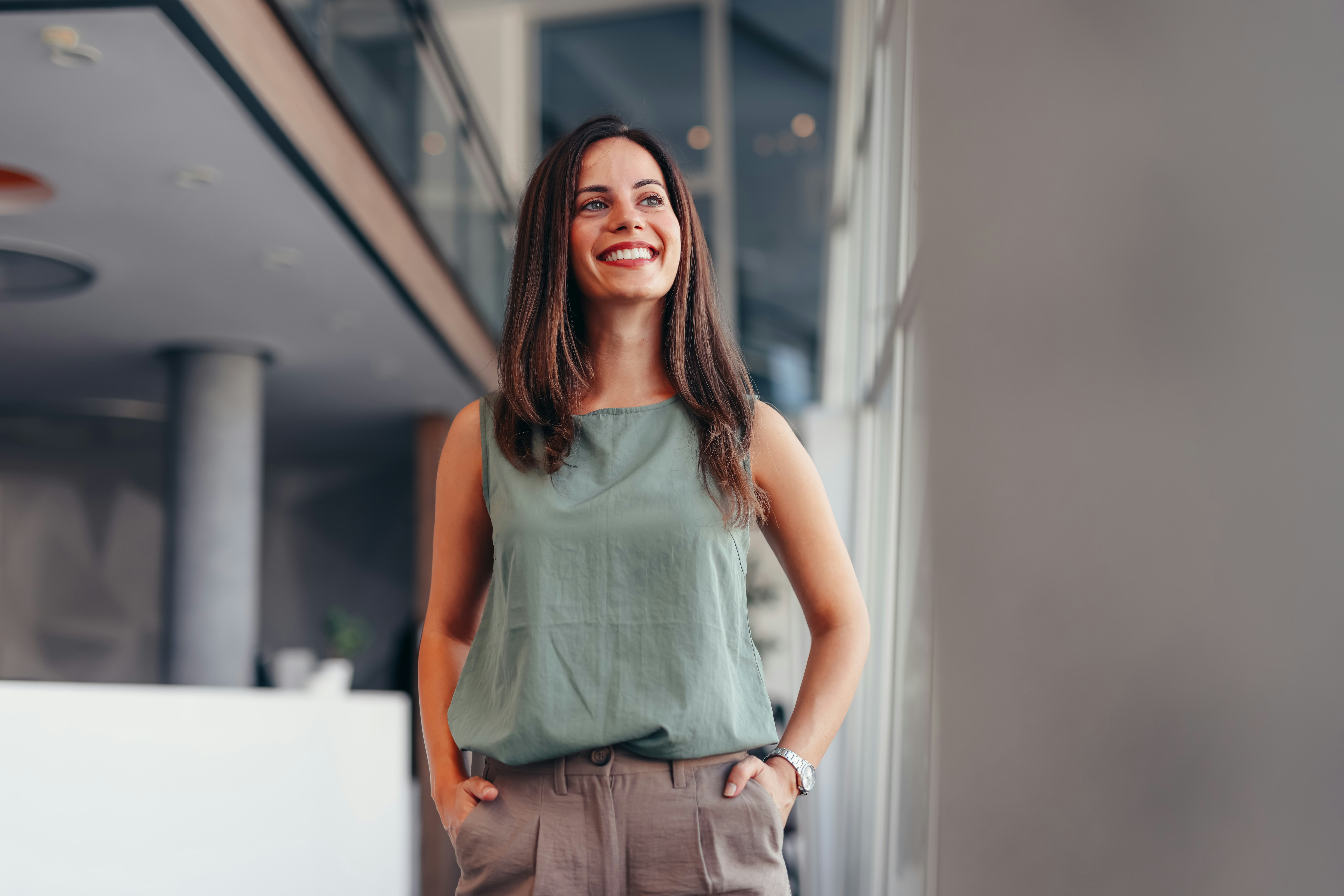 Waist up portrait modern business woman in the office looking away with copy space. Female executive...