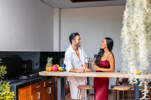 Young couple drinking white wine in a villa in Bali in Indonesia.