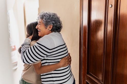 Grandmother welcoming granddaughter at home
