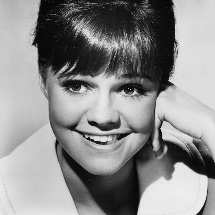 1965: Studio headshot of American actor Sally Field smiling with her hand on her cheek. Field starr...