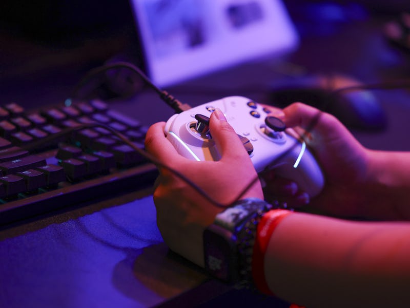 A visitor plays Final Fantasy XIV with an Xbox games controller at the Gamescom computer gaming fair...