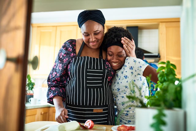 Black woman and teenage daughter preparing food, bonding, togetherness, love