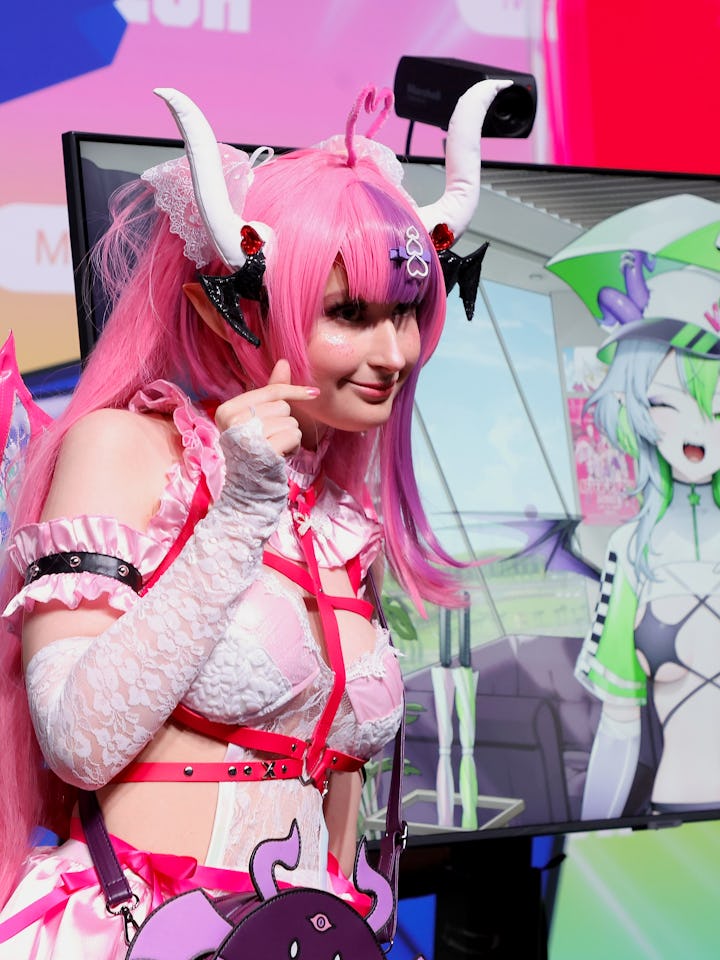 SAN DIEGO, CALIFORNIA - SEPTEMBER 20: Attendee poses with VTuber Ironmouse at TwitchCon 2024 San Die...
