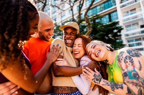 LGBTQIA+ friends embracing and talking outdoors