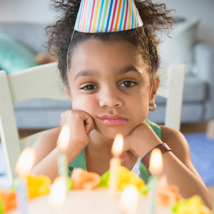 A birthday girl looks grumpy at her party. Parents share the worst holidays to share with a birthday...