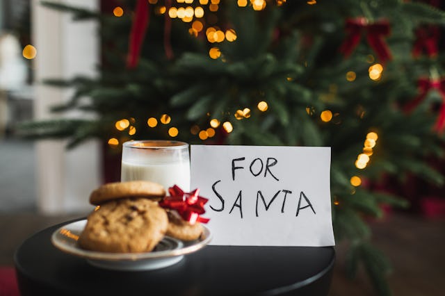 Child make surprise present for Santa claus milk and oat cookie. Xmas family tradition, Childhood, h...