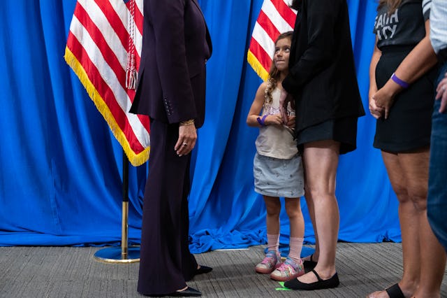 TOPSHOT - A young girl looks up at US Vice President and Democratic presidential candidate Kamala Ha...