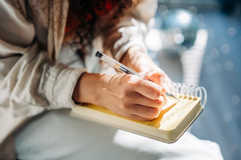 Woman Writing in her Notebook, Making a To-do List.