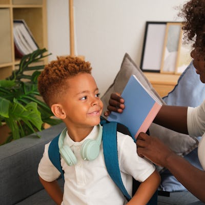 Mother helping her son getting ready for school. The study showed that reframing tasks as learning opportunities led to a reduction in parents taking over tasks for their kids.