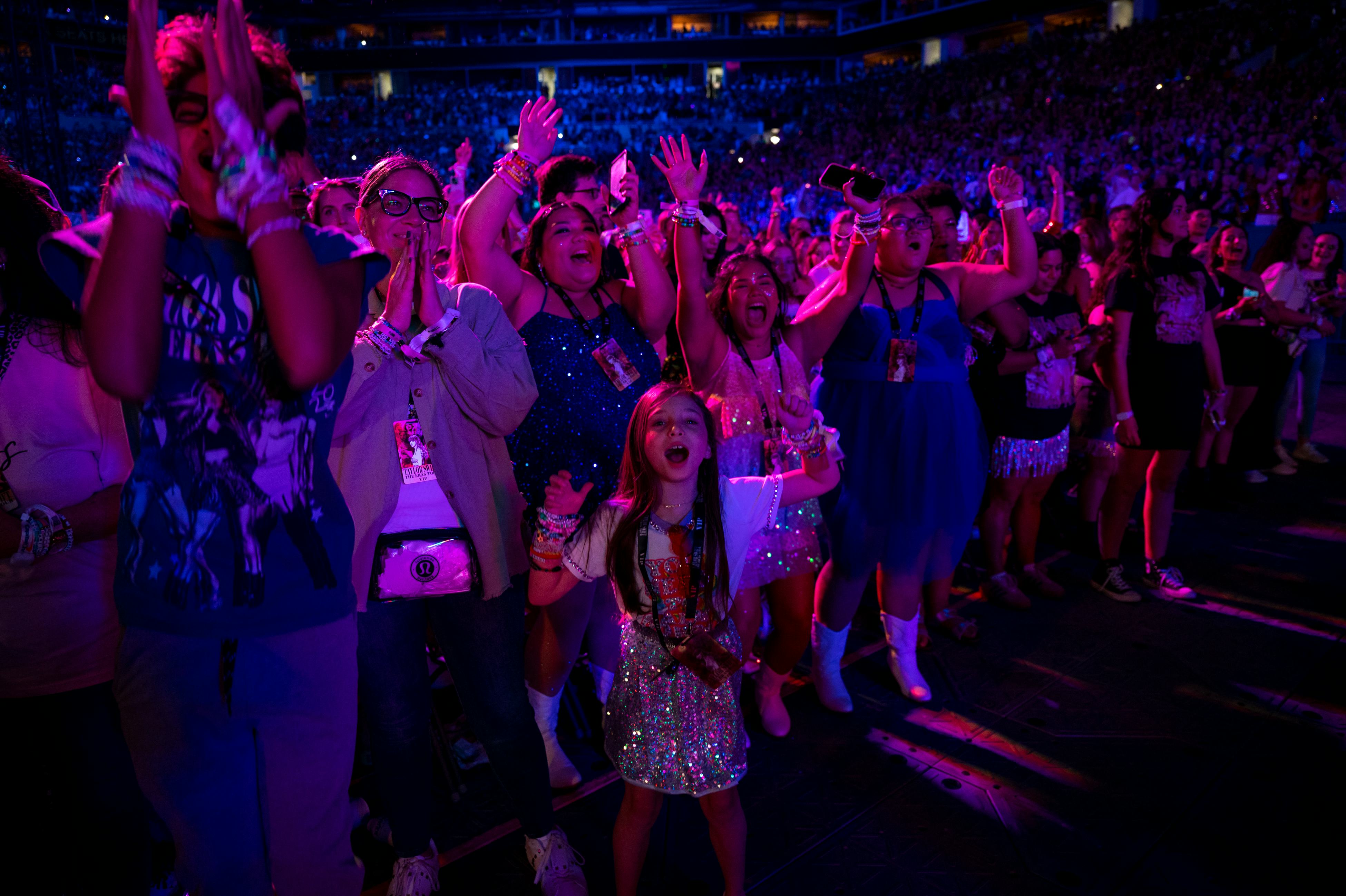 Fans cheer on Taylor Swift on The Eras Tour.