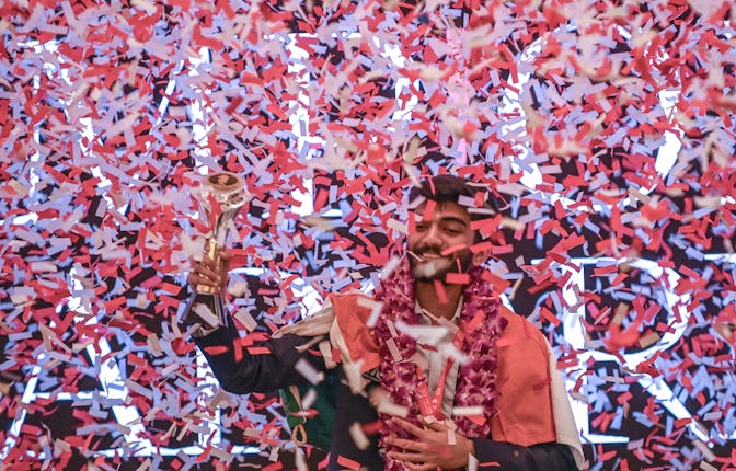 India's Gukesh Dommaraju celebrates with the World Chess Championship 2024 trophy after beating Chin...